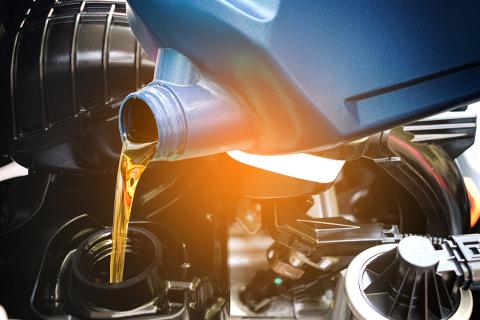 oil being poured into car change with light gradient overlay